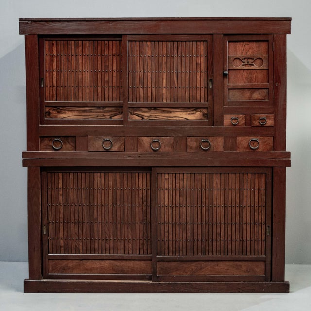 A gorgeous antique Japanese two piece kitchen tansu chest (Goshu Mizuya) from the late Meiji period. This stunning tansu...