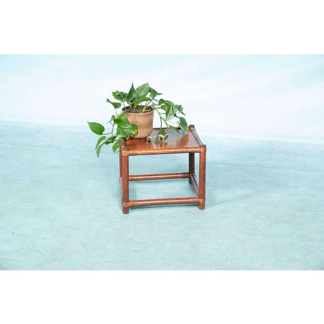 Sleekly designed square coffee table made of rattan and wood. Can serve as a coffee table or as a side table between two...