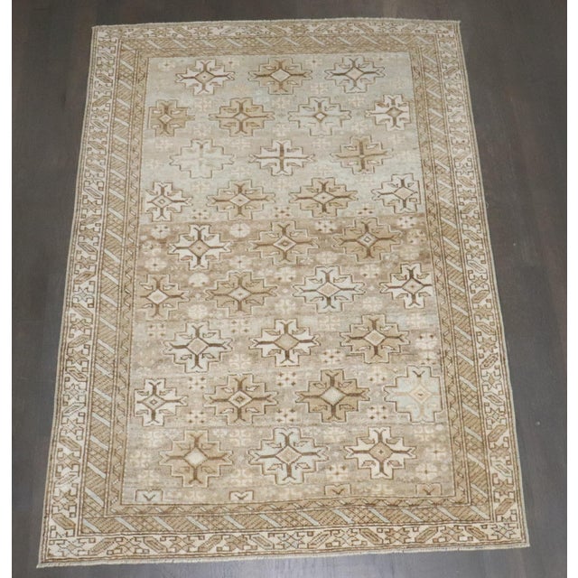 An early 20th century caucasian shirvan rug in light green and neutral tones