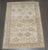 An early 20th century caucasian shirvan rug in light green and neutral tones