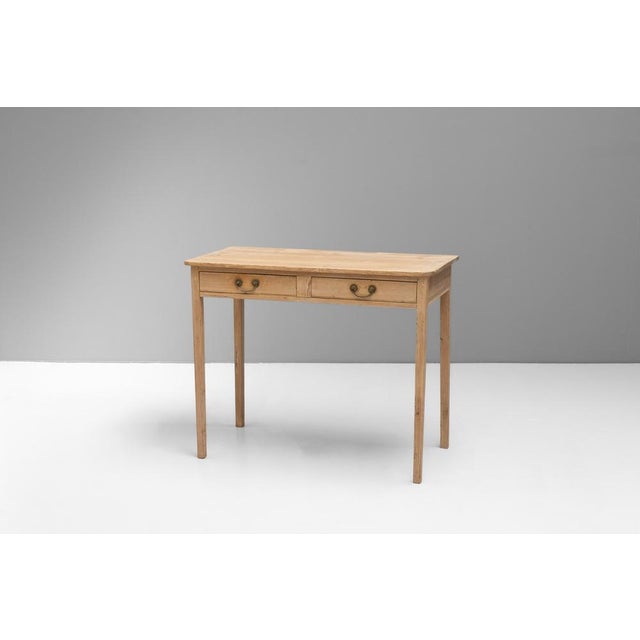 Two drawer pine side table on square tapered legs. Circa 1820.