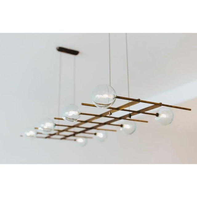 Modular fat 8 lamps pendant by contain dimensions: d 130 x h 54 cm (custom length). Materials: brass structure, blown...