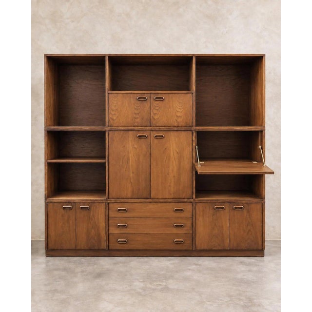 A substantial vintage three-piece modular wood bookcase made from three horizontal units that stack into one architectural...