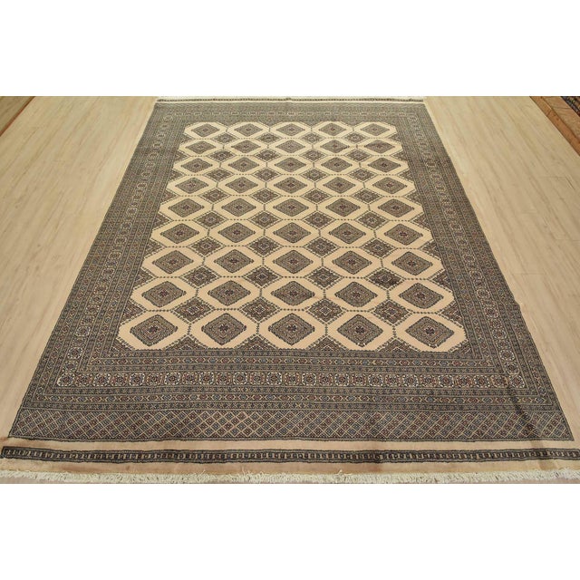 A tribal Bokhara Jaldar rug hand-knotted with fine wool on a cotton foundation. This rug features rows of repeating...