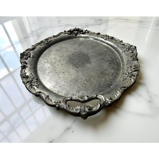 A large Reed & Barton King Francis pattern silver plate serving tray. The ornately etched surface of the tray and high...