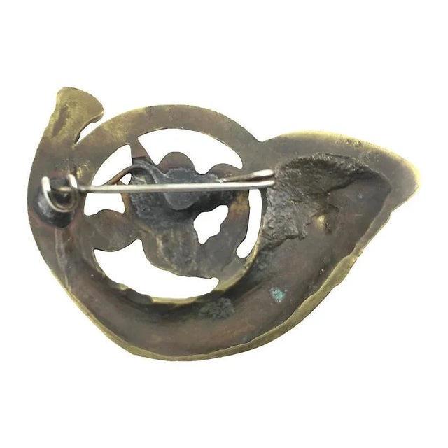 Highly stylized French horn brooch with a monogram in the center. No maker's mark. Age wear, tarnished, light scratches....