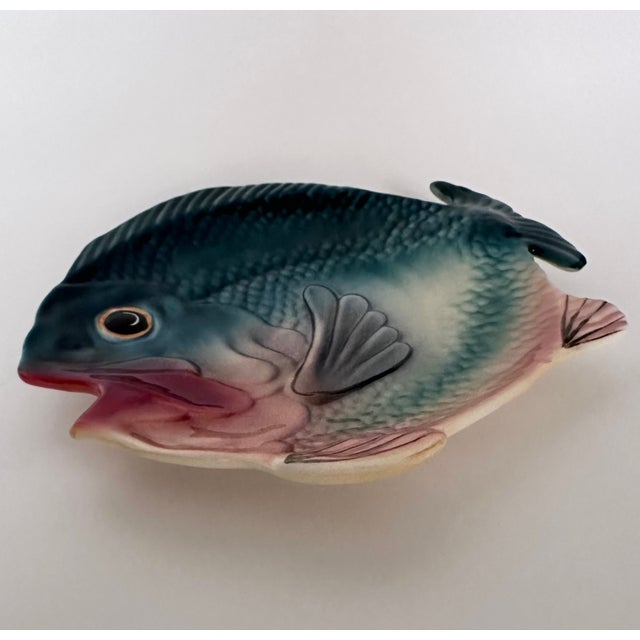 Collectible Brad Keeler hand-painted ceramic individual fish plate, finished in rich teal green, apricot and maroon. It is...