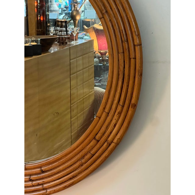 This is a beautiful Italian imported burnt bamboo rattan round mirror. In excellent condition. Measures: 30" diameter