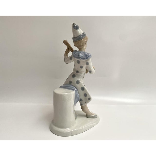 This porcelain Pierrot figurine, hand-painted with underglaze techniques, embodies the charm and artistry of Spanish...