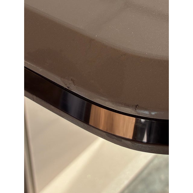 Beautiful high quality dining table with a glossy cream finish smoked glass center insert, elegant rose gold trim, and...