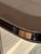 Beautiful high quality dining table with a glossy cream finish smoked glass center insert, elegant rose gold trim, and...