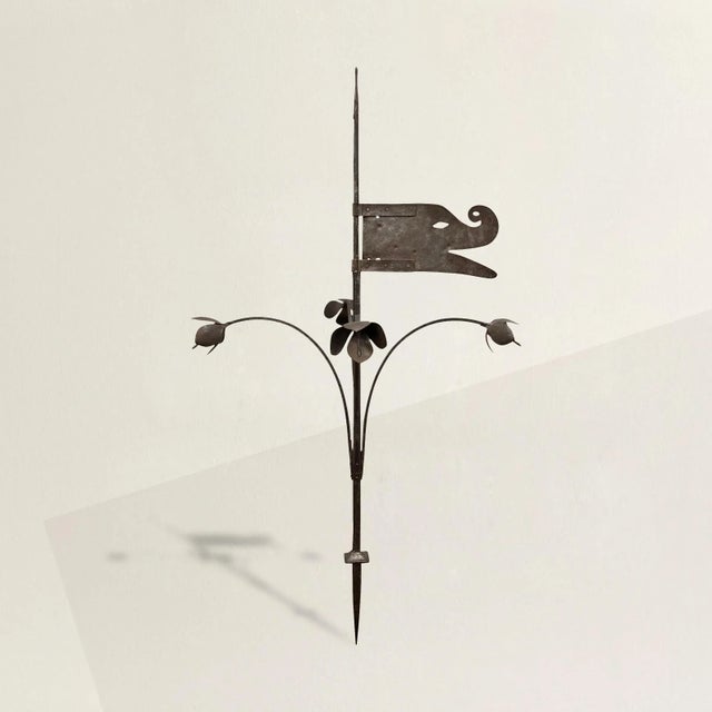 A stunning and rare 18th century French hand-wrought iron weathervane, from Normandy, with a stylized dragon "flag" the...