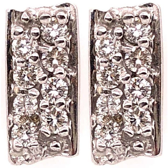 Button White Gold Earrings with 16 Diamonds 2 grams total weight .