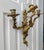 These are a pair of antique Rococo style solid brass three-arm candle wall sconces. They are likely from the 1920s and...