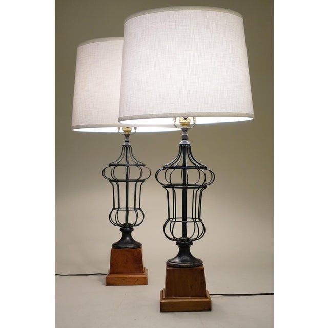 A distinguished and impressive matched pair of early French styled Neoclassical wire caged Urn form with Maple wood...