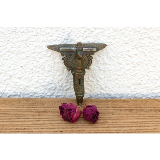 A robust utilitarian antiquity featuring a detailed geometric stem and a stylized architectural bud finial, carrying a...