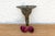 A robust utilitarian antiquity featuring a detailed geometric stem and a stylized architectural bud finial, carrying a...