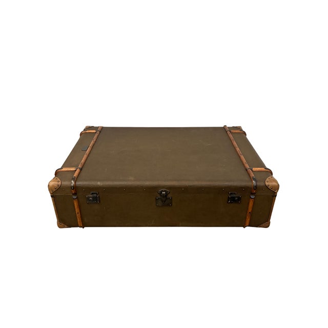 Large decorative campaign-style steamer trunk featuring a brown canvas-covered case, wood slat trim, leather-look corner...