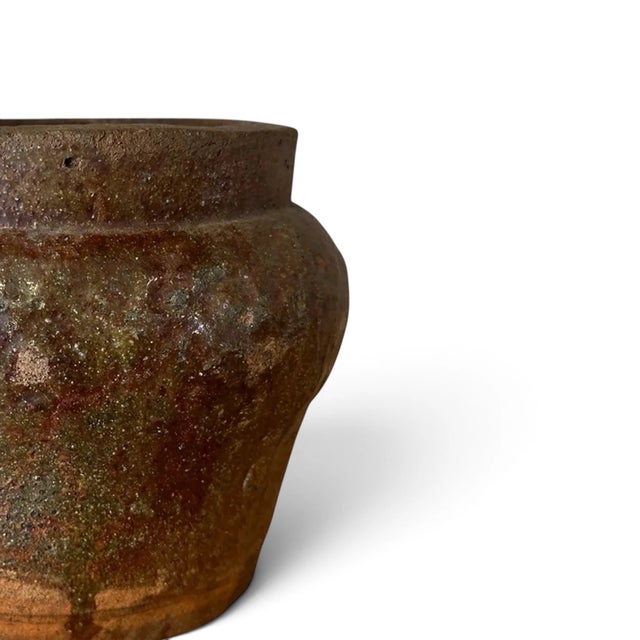 A piece of Indonesian daily life, preserved in clay. This vintage vessel was handcrafted by local artisans using...