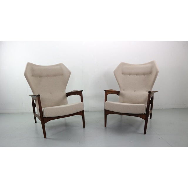 Set of two wingback lounge chairs designed by Ib Kofod-Larsen in 1954. The chairs are reclinable and it can be adjusted in...