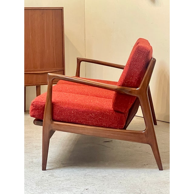 A gorgeous Mid-Century Danish teak 3-Seater sofa attributed to Koefed Larsen for Selig (c. 1960). It seats three people...