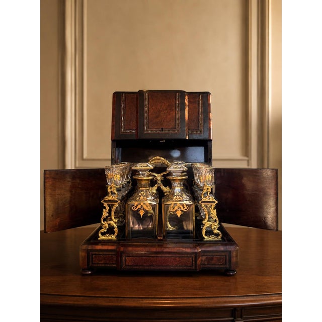 A striking 19th century French cave à liqueur, beautifully crafted in richly figured wood with mother-of-pearl inlay,...