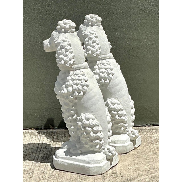 Add timeless charm and whimsical sophistication to your garden or interior with this pair of vintage cement French poodle...
