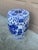 A classic blue and white porcelain garden stool, decorated with traditional Chinese scenes and motifs and stylized floral...