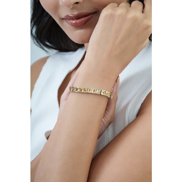 This Certified 20.98 Ct Natural Citrine Statement Tennis Bracelet features a continuous row of square-cut citrine...