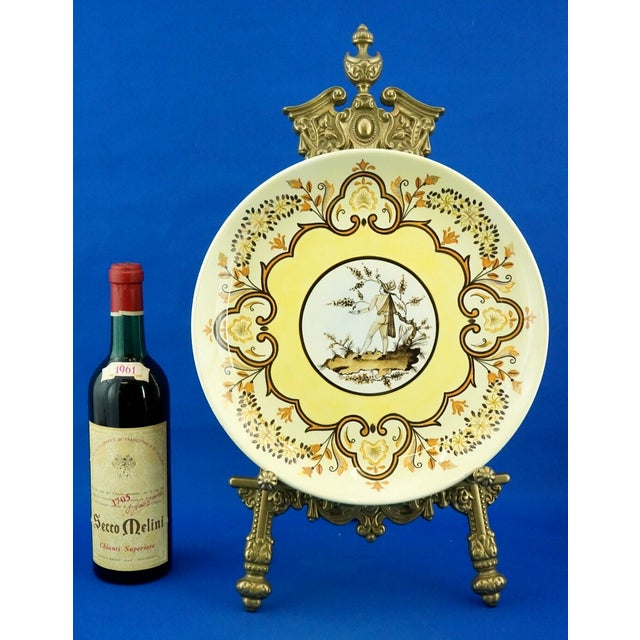 Item : A magnificent large glazed ceramic plate, entirely hand-decorated with floral garland decorations and a central...