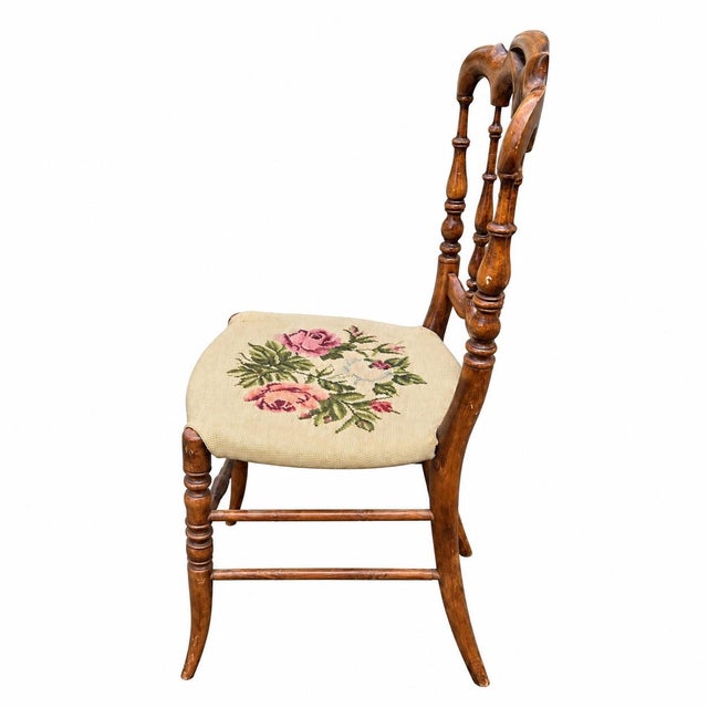 Charming antique Victorian-era accent chair featuring an intricately carved and turned wooden frame with an elegant...