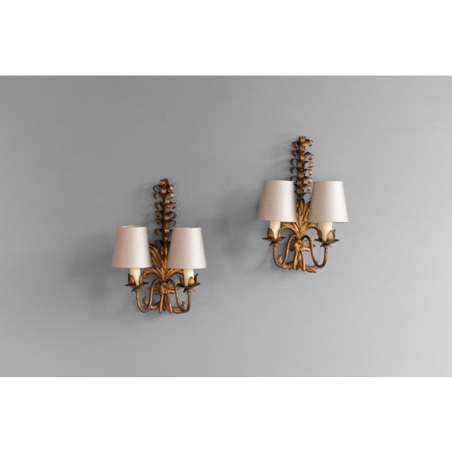 Pair of steel wall sconces with original gold finish. Circa 1950. Up to 250V (Europe/UK Standard).The wiring of this item...