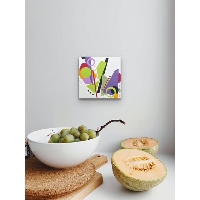 This artwork features a dynamic arrangement of bold geometric shapes and vibrant colors, creating a sense of movement and...