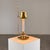 A refined bouillotte table lamp from 1940s italy, crafted in brass with a height-adjustable shade. Its design is minimal...