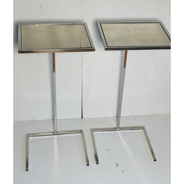Pair of elegant simple design Siede glass spot side tables on chrome bases.