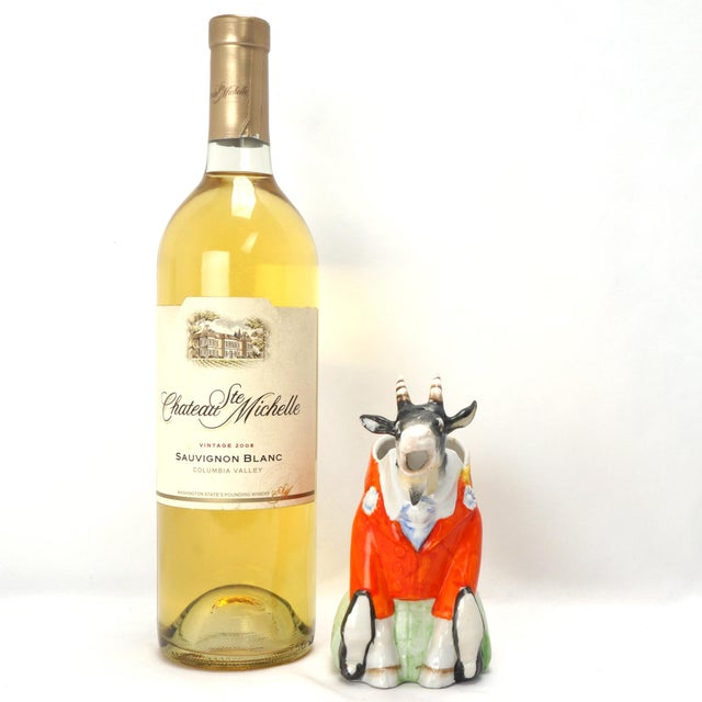 A whimsical hand-painted creamer in the shape of a goat dressed up in a human tailcoat, pants and shoes. He even has a...