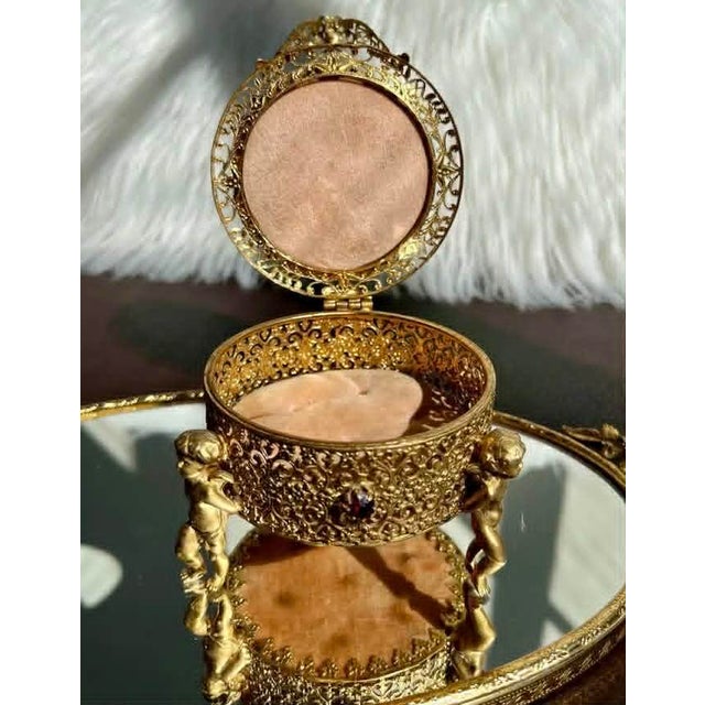 Beautiful three-footed cherub, vintage jewelry casket with pink plush coating on top and inside, in very good vintage...