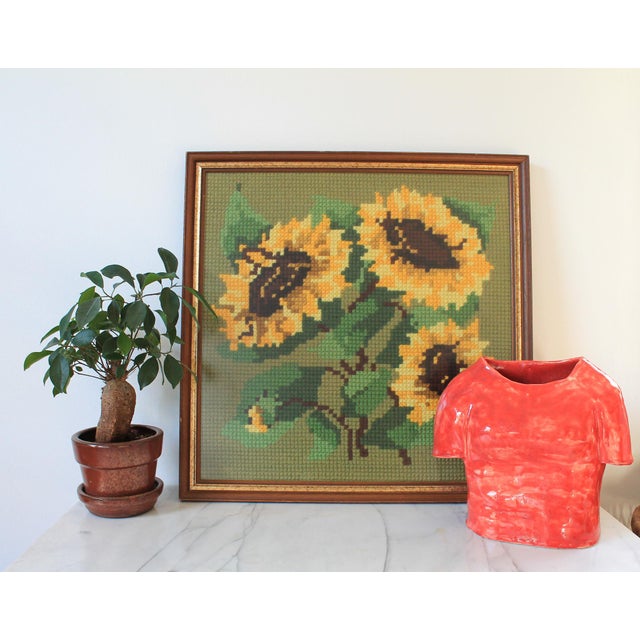 Vintage sunflower needlepoint wall hanging in a wood frame. No makers mark. Some light age wear to wood frame. Ready to hang.