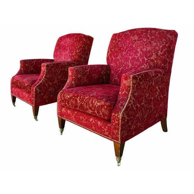 Offered here is a pair of lounge chairs by Baker Furniture. Each chair is upholstered in a red velvet textile and down-...