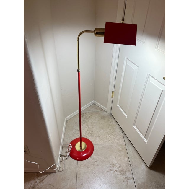 This item is a Mid-Century Modern red enamel and polished brass pharmacy floor lamp, a style popularized in the 1950s...