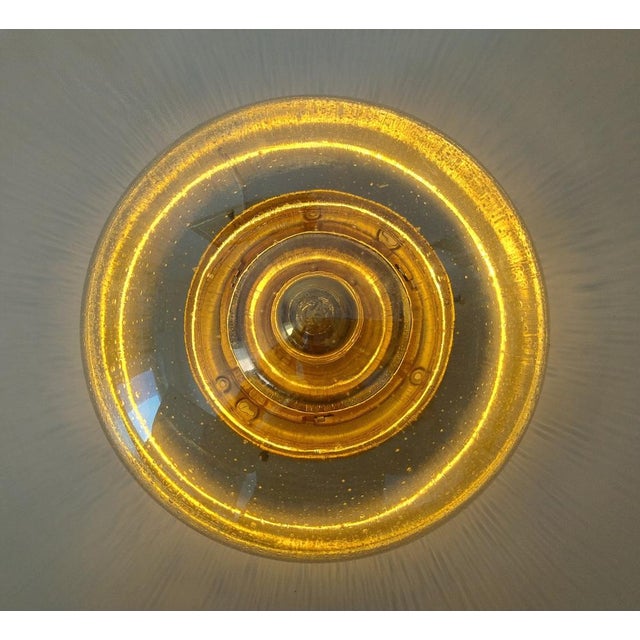 Space Age flush mount ceiling light featuring a hand-blown bubble glass dome and brass fittings. The textured glass...