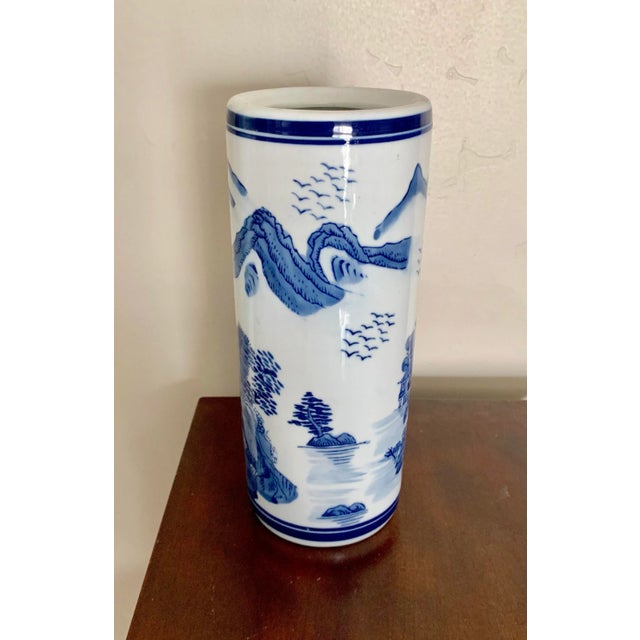 Blue and white traditional 10” high tubular ceramic vase with handpainted scenery design. Great for a mantel or side table...