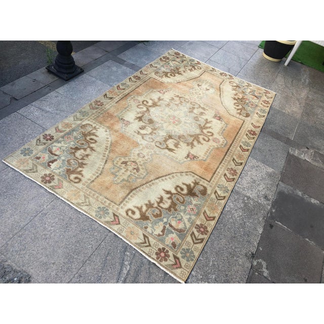 This is a vintage Turkish Oushak rug from the 1960s. The piece was hand-knotted