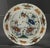 Аn stunning garniture of three early faience dishes A large Dutch Delft polychrome charger and two plates, naively painted...