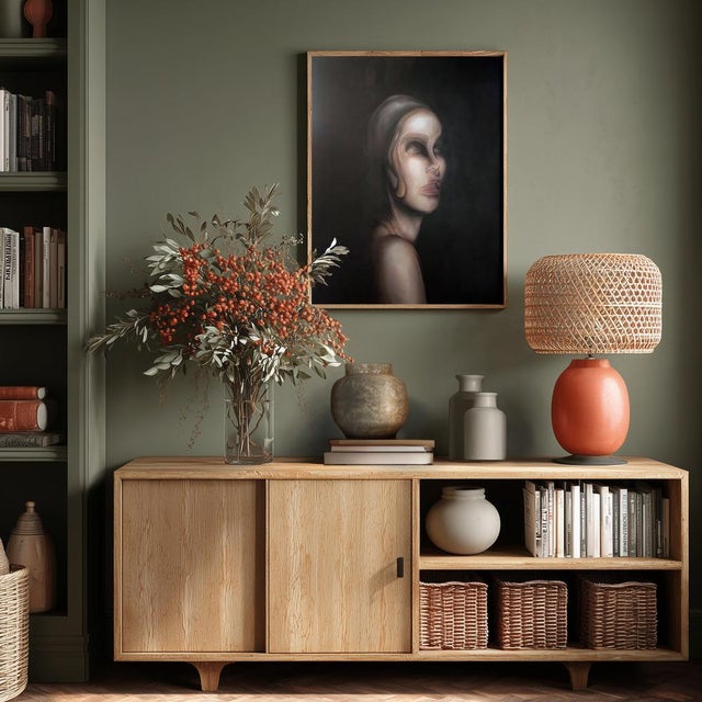 The work captures a female figure emerging from deep darkness, masterfully painted in oil on canvas. The face, delicately...