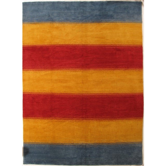 Vintage hand-knotted Gabbeh rug with broad horizontal bands and subtle tonal variation. Woven in wool with a simple,...