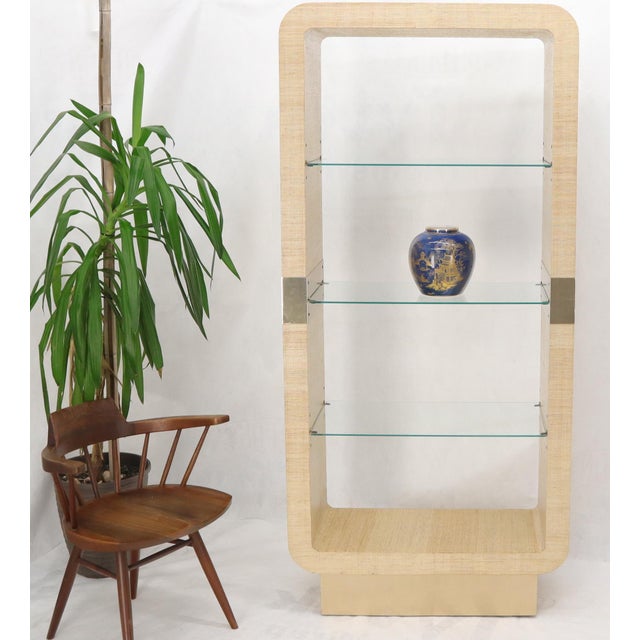 Raffia cloth wrapped Mid-Century Modern display wall unit étagère shelves.
