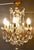 A Charming French Crystal 6 Branch Brass Chandelier This is a superb brass chandelier, the brass has a gilded finish and...