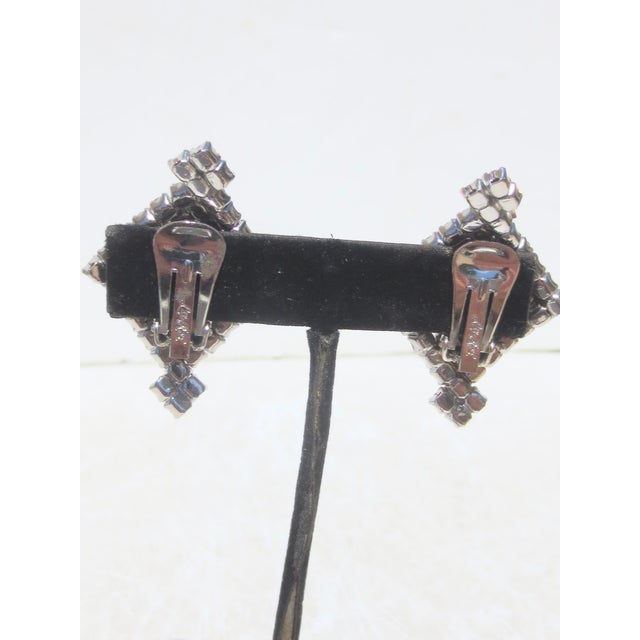 Signed La Rel to the back of the clips, Rhine Stone diamond shapes with crests at the top and bottom—silver metal and...