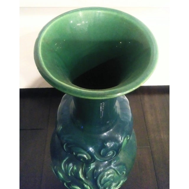 A tall vintage Haegar decorative floral carved front vase. The vase has such a pretty teal blue green color and is marked...